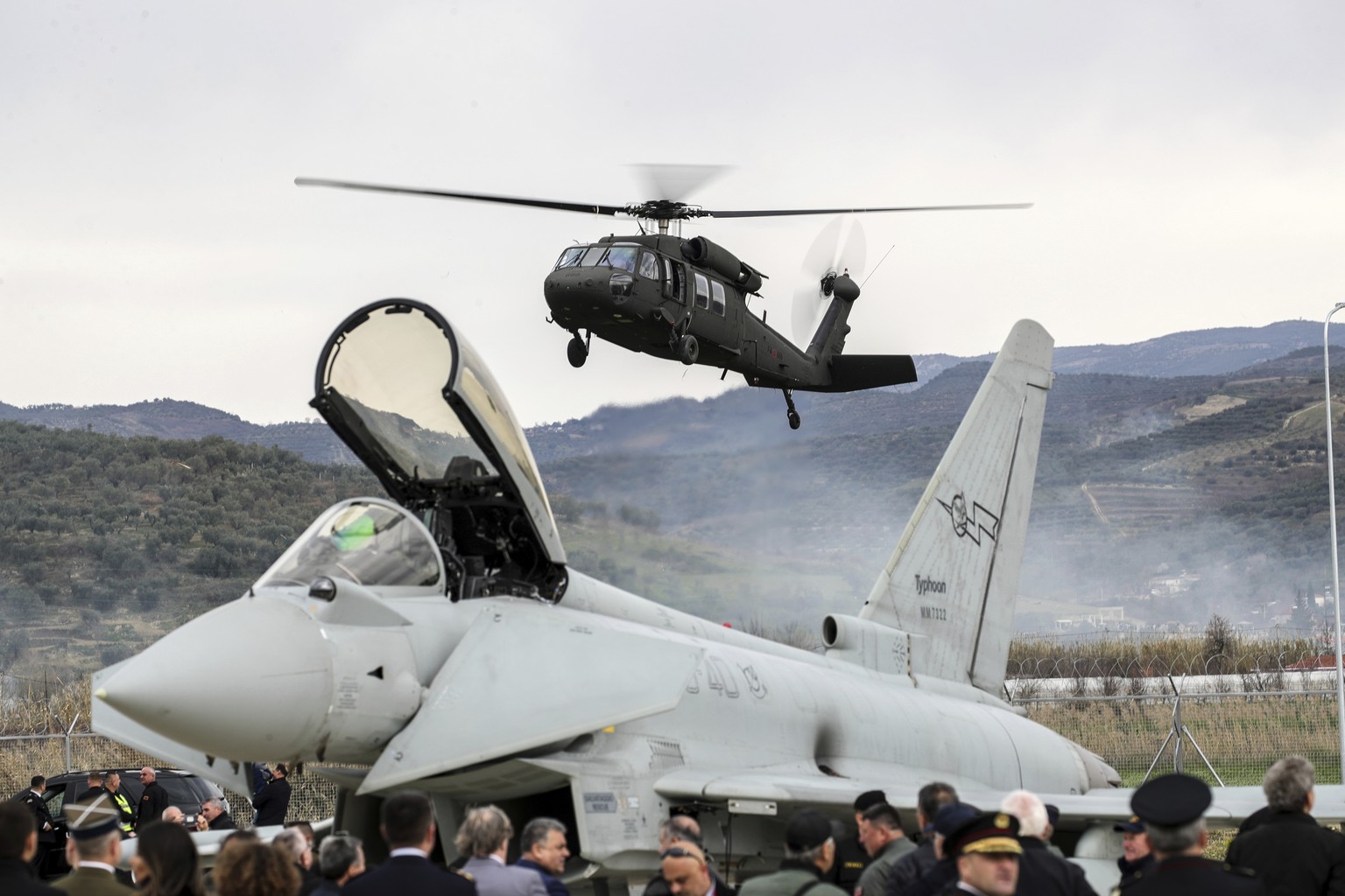 A military helicopter lands near an Italian Eurofighter at an airbase during a ceremony, in Kocuve, about 85 kilometers (52 miles) south of Tirana, Albania, Monday, March 4, 2024. NATO member Albania  ...