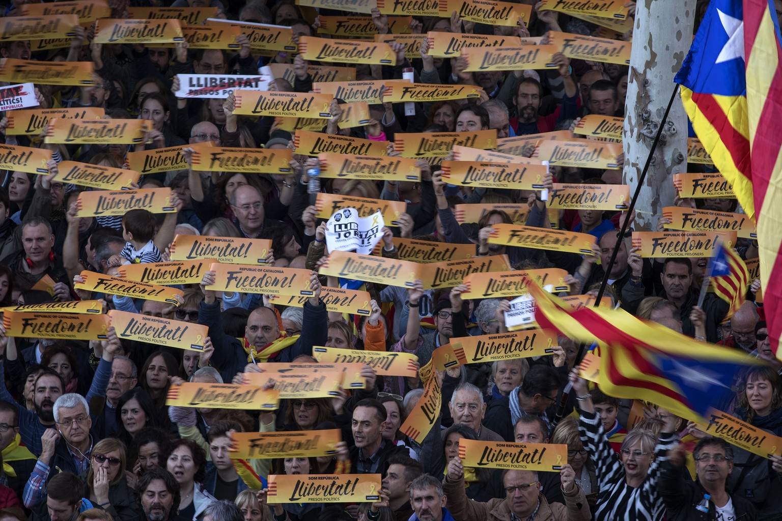Demonstrators hold banners as they take part at a protest calling for the release of Catalan jailed politicians, in Barcelona, Spain, on Saturday, Nov 11, 2017. Eight members of the now-defunct Catala ...