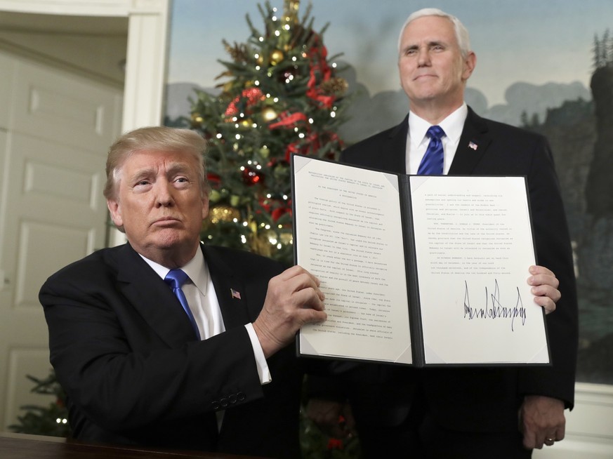 President Donald Trump holds a proclamation to recognize Jerusalem as the capitol of Israel in the Diplomatic Reception Room of the White House, Wednesday, Dec. 6, 2017, in Washington, as Vice Preside ...