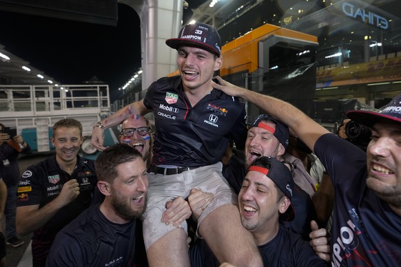 Red Bull driver Max Verstappen of the Netherlands celebrates with his team after he became the world champion after winning the Formula One Abu Dhabi Grand Prix in Abu Dhabi, United Arab Emirates, Sun ...