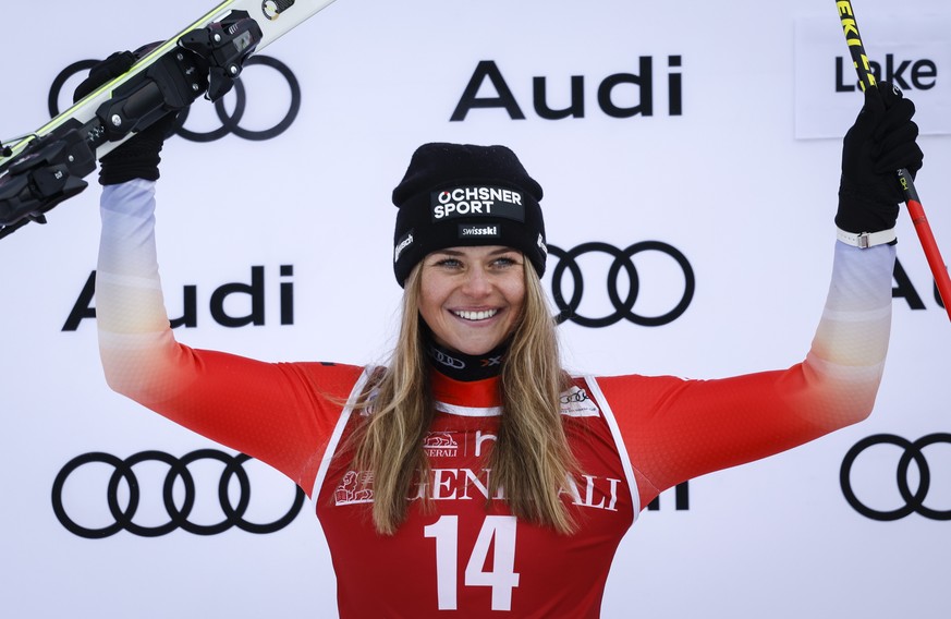 Second-place finisher Switzerland&#039;s Corinne Suter, celebrates on the podium following the women&#039;s World Cup downhill ski race in Lake Louise, Alberta, Friday, Dec. 2, 2022. (Jeff McIntosh/Th ...