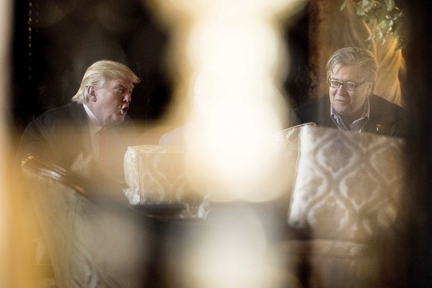 President-elect Donald Trump, left, and chief strategist Steven Bannon, right, talks as they attend a meeting at Mar-a-Lago, in Palm Beach, Fla., Wednesday, Dec. 21, 2016. (AP Photo/Andrew Harnik)