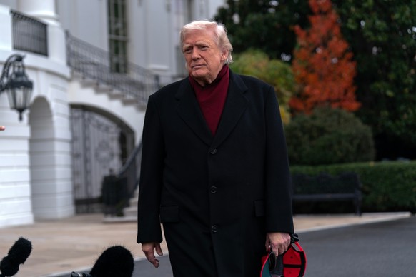 President Donald Trump talks to reporters as he departs from the South Lawn of the White House, Saturday, Nov. 22, 2025, in Washington, en route to Joint Base Andrews. (AP Photo/Jose Luis Magana)
Dona ...