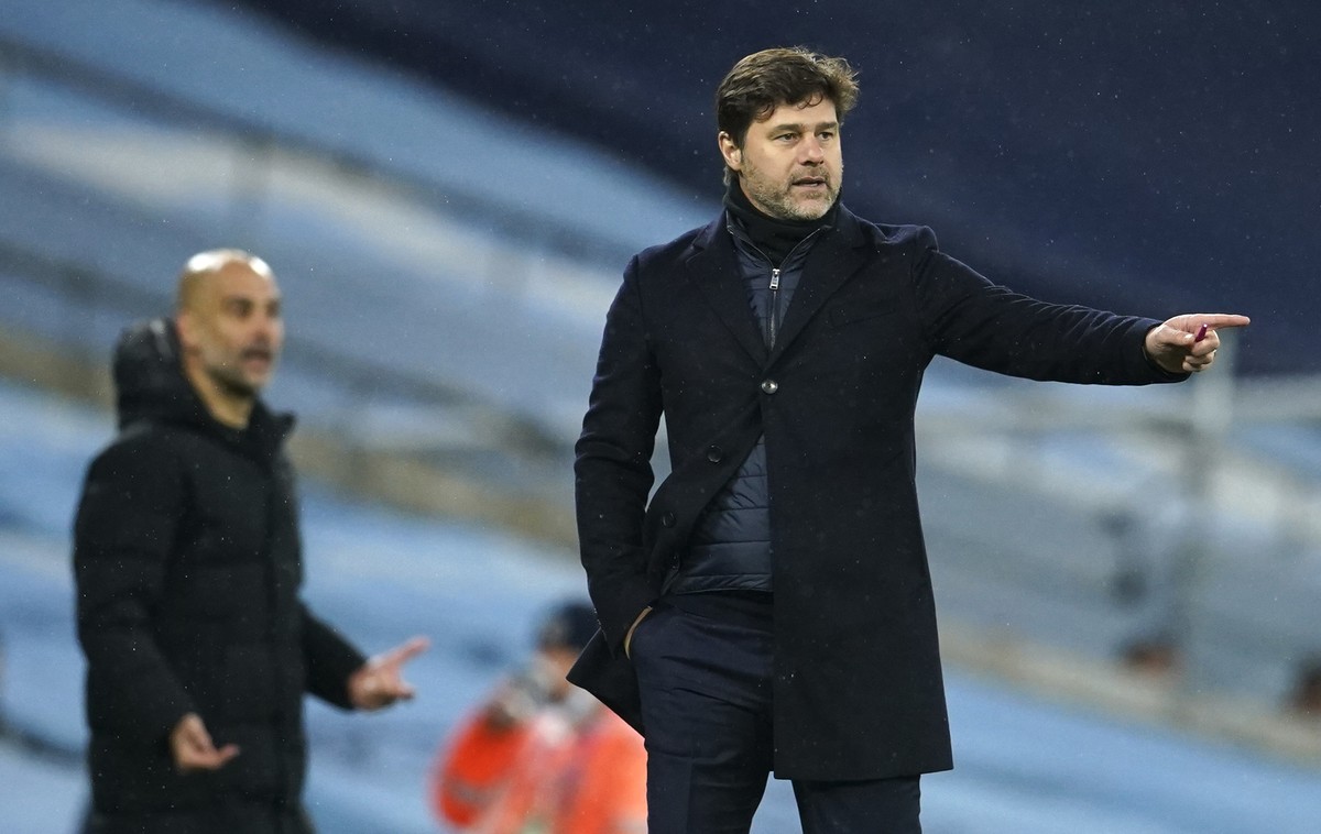 PSG's head coach Mauricio Pochettino, right, and Manchester City's head coach Pep Guardiola gesture during the Champions League semifinal second leg soccer match between Manchester City and  ...