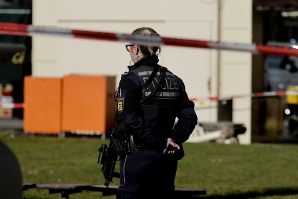 epa11938008 A police officer stands guard near the scene after a vehicle was driven into pedestrians in Mannheim, Germany, 03 March 2025. According to statements from police, a vehicle drove into a cr ...