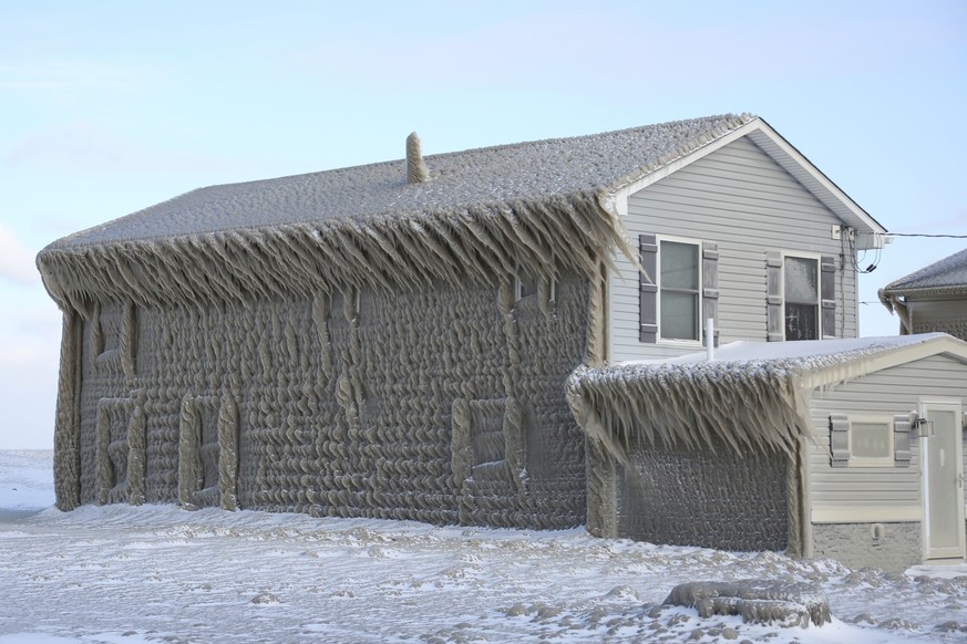 A house along Hoover Beach is covered by ice from high winds and from the waves from Lake Erie, Saturday, Feb. 29, 2020, in Hamburg N.Y. Blowing snow has fallen around the state since Thursday, though ...