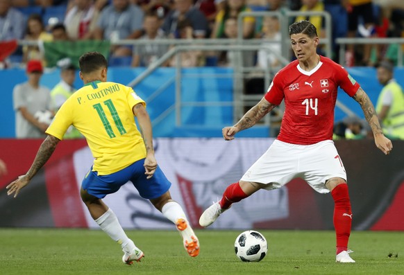 Switzerland&#039;s Steven Zuber, right, duels for the ball with Brazil&#039;s Philippe Coutinho during the group E match between Brazil and Switzerland at the 2018 soccer World Cup in the Rostov Arena ...