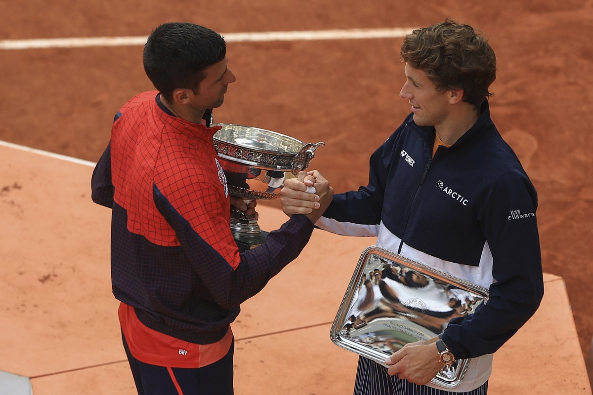 Serbia's Novak Djokovic, left, shakes hands with Norway's Casper Ruud after their final match of the French Open tennis tournament at the Roland Garros stadium in Paris, Sunday, June 11, 202 ...