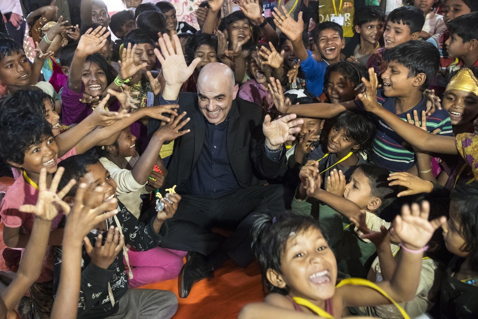 Swiss Federal President Alain Berset is surrounded by children during a visit in the Kutupalong Rohingya refugee camp in Cox's Bazar, Bangladesh, during Berset's four days official visit to ...