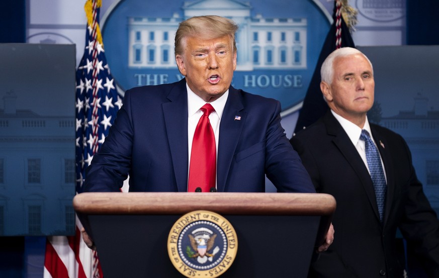 epa08839597 US President Donald J. Trump joined by Vice President Mike Pence (R), delivers brief remarks on the stock market and the Dow reaching 30,000 for the first time in history, at the White Hou ...