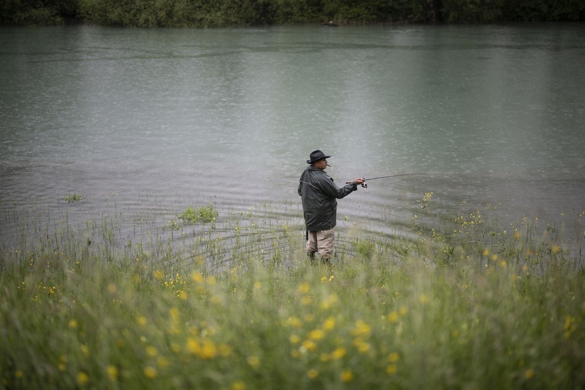 Ein Fischer an der Linth bei der Einmuendung zum Walensee, am Donnerstag, 11. Mai 2023, in Weesen. Die andauernden Niederschlaege der vergangenen Woche sorgen fuer eine Entpannung, nachdem der Winter  ...