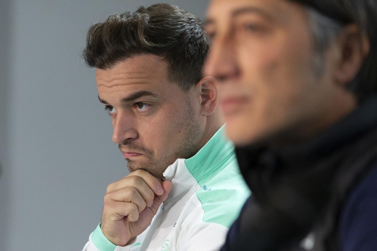 Switzerland's midfielder Xherdan Shaqiri, left, sitting next to Switzerland's head coach Murat Yakin, right, speaks to the media, during a press conference of the national soccer team Switze ...