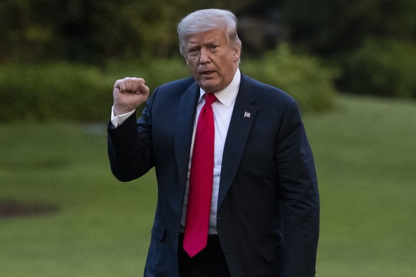 President Donald Trump pumps his fist as he walks on the South Lawn after arriving on Marine One at the White House, Thursday, June 25, 2020, in Washington. Trump is returning from Wisconsin. (AP Phot ...