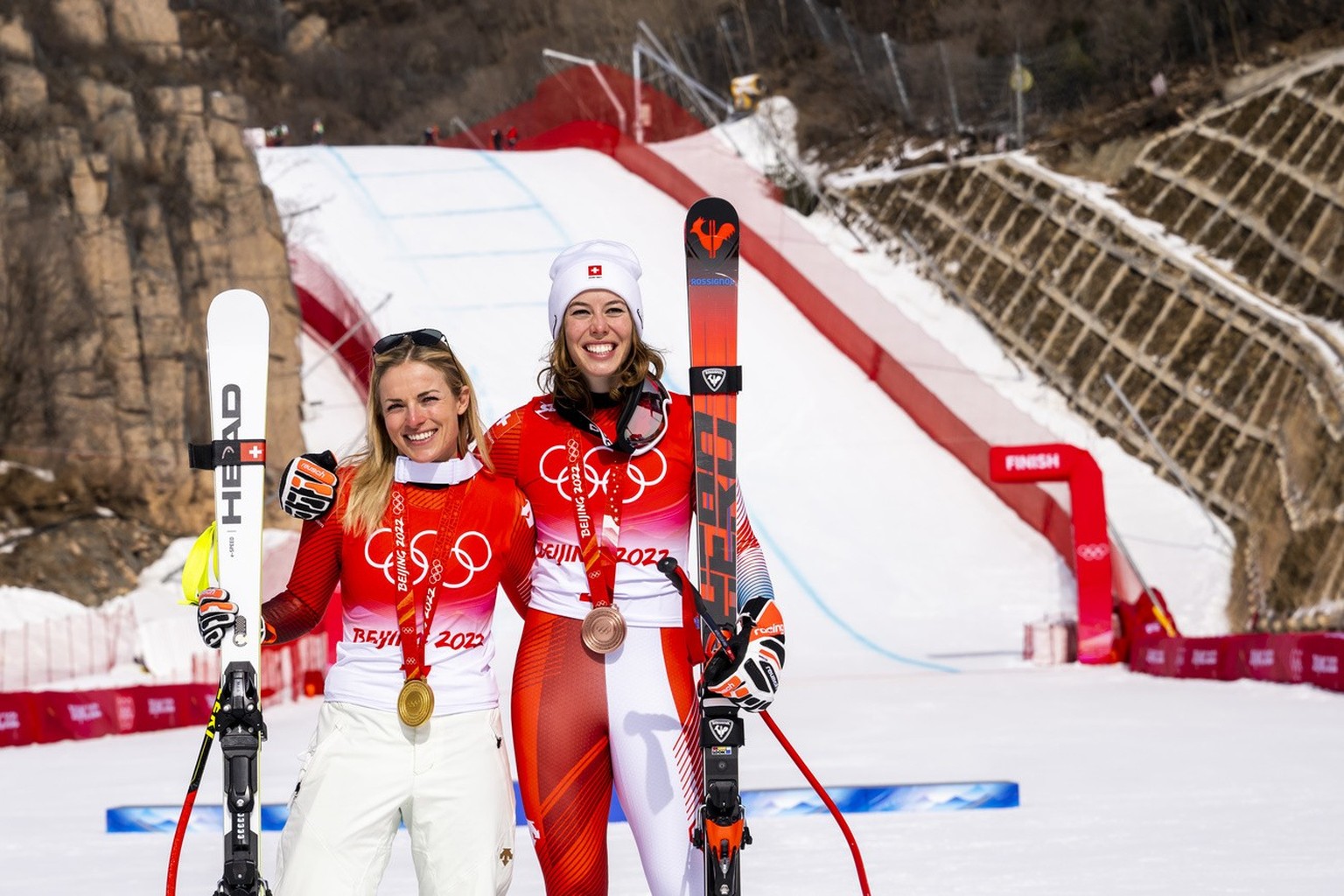 Gold medalist Lara Gut-Behrami of Switzerland, left, celebrates with bronze medalist Michelle Gisin of Switzerland, right, during the victory ceremony of the women&#039;s Alpine Skiing Super-G race at ...