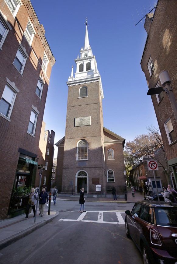 In this Wednesday, Nov. 7, 2018 photo, Old North Church stands among buildings in the North End neighborhood of Boston. A bronze wreath and plaque that forms part of a memorial, which includes thousan ...