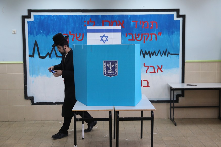 epa07493506 An Ultra-Orthodox Jewish man casts his vote at a booth at a polling station during the Israel general elections in Jerusalem, Israel, 09 April 2019. Nearly 6.3 million Israelis are eligibl ...