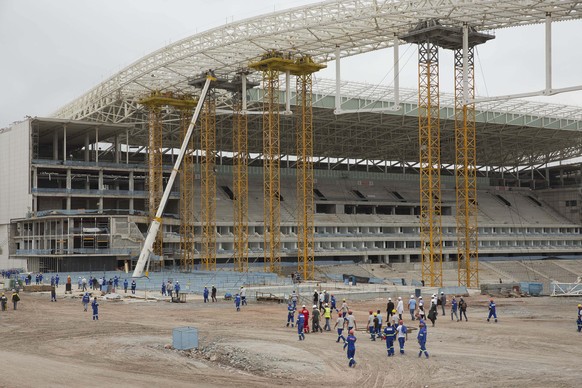 FILE - In this Dec. 2, 2013, file photo, Construction workers return to the Arena Corinthians stadium that will host the opening match of the World Cup, five days after an accident killed two workers, ...