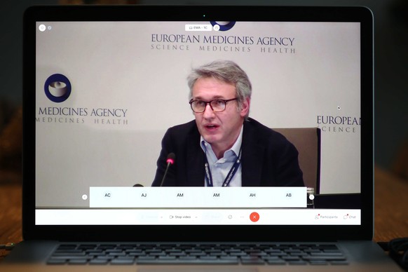 epa08898083 epa08898074 A photo taken off the screen of a laptop shows Marco Cavaleri, Head of Biological Health Threats and Vaccines Strategy, explaining the approval of the Pfizer / BioNTech coronav ...