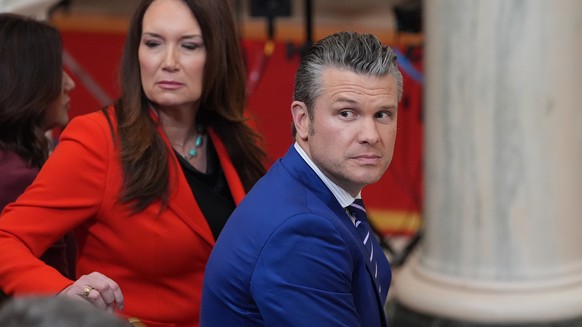 epa12865485 US Defense Secretary Pete Hegseth (R) and US Agriculture Secretary Brooke Rollins (L) arrive before President Donald Trump speaks about the Iran war from the Cross Hall of the White House  ...