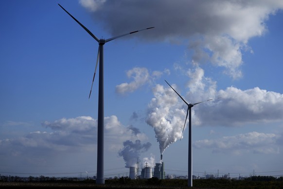 The Schkopau coal-fired power plant operates near wind turbines in Teutschenthal, near Halle, eastern Germany, Tuesday, Oct. 15, 2024. (AP Photo/Matthias Schrader)