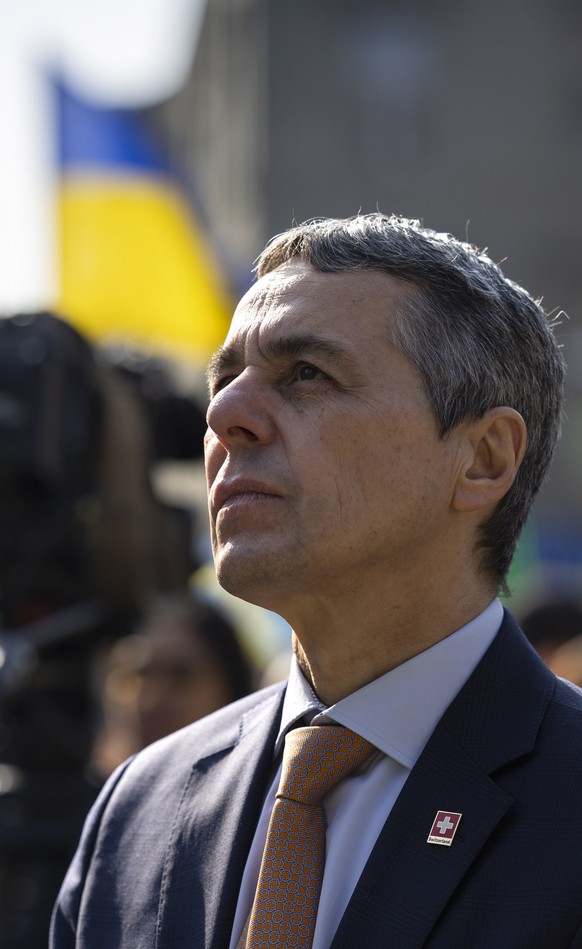 epa09836063 Swiss Federal President Ignazio Cassis listens to the speech of Ukrainian President Volodymyr Zelensky, during a demonstration against the Russian invasion of Ukraine in front of the Swiss ...