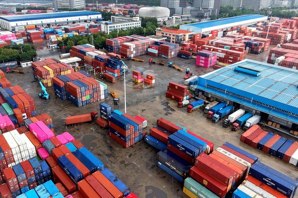 Containers are loaded and unloaded in trucks at terminal in Qingdao in eastern China's Shandong province on Aug. 28, 2026. (Chinatopix via AP)
China Economy