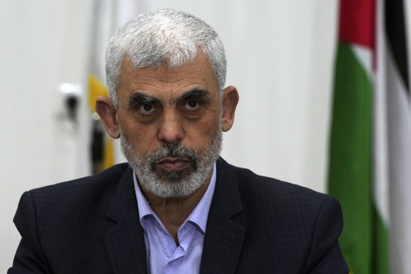 FILE - Yahya Sinwar, head of Hamas in Gaza, chairs a meeting with leaders of Palestinian factions at his office in Gaza City, Wednesday, April 13, 2022. The Hamas officials are accused by the ICC of p ...