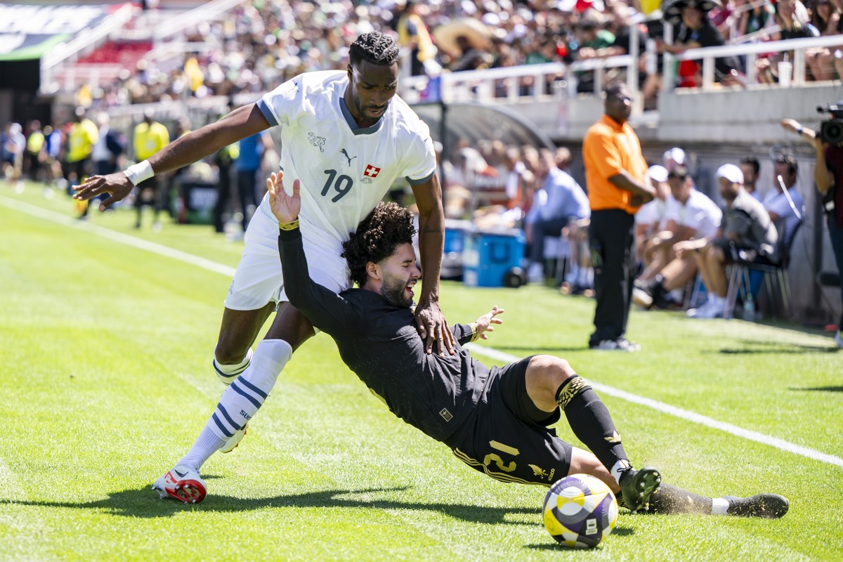 Switzerland's Ulisses Garcia, left, fights for the ball with Mexico's Cesar Huerta, right, during a Friendly soccer match between Mexico and Switzerland at the Rice-Eccles Stadium, in Salt L ...