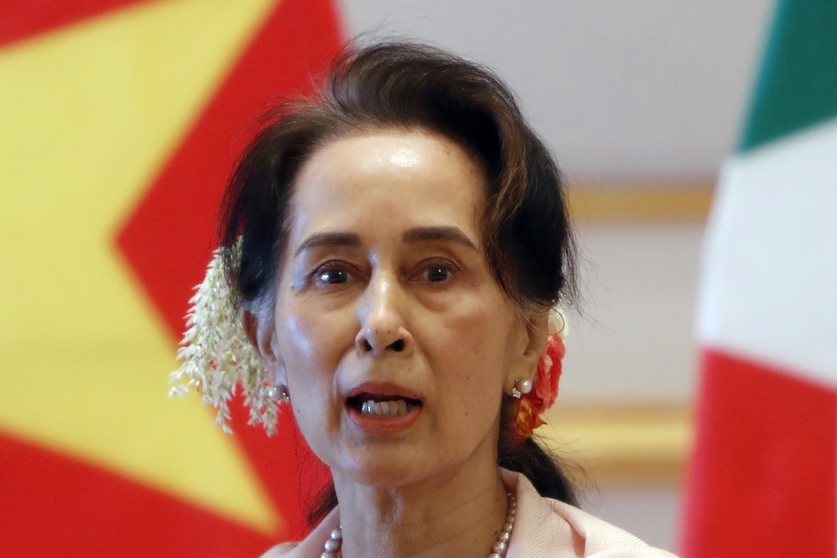 FILE - In this Dec. 17, 2019, file photo, then Myanmar's leader Aung San Suu Kyi speaks during a joint press conference with Vietnam's Prime Minister Nguyen Xuan Phuc after their meeting at  ...