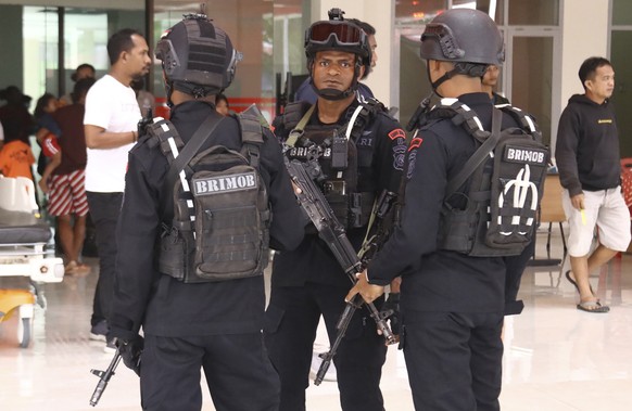 Police guard a hospital where workers threatened by Papuan rebels were brought for medical examinations in Mimika, Papua province, Indonesia, Wednesday, Feb. 8, 2023. Security forces evacuated the wor ...