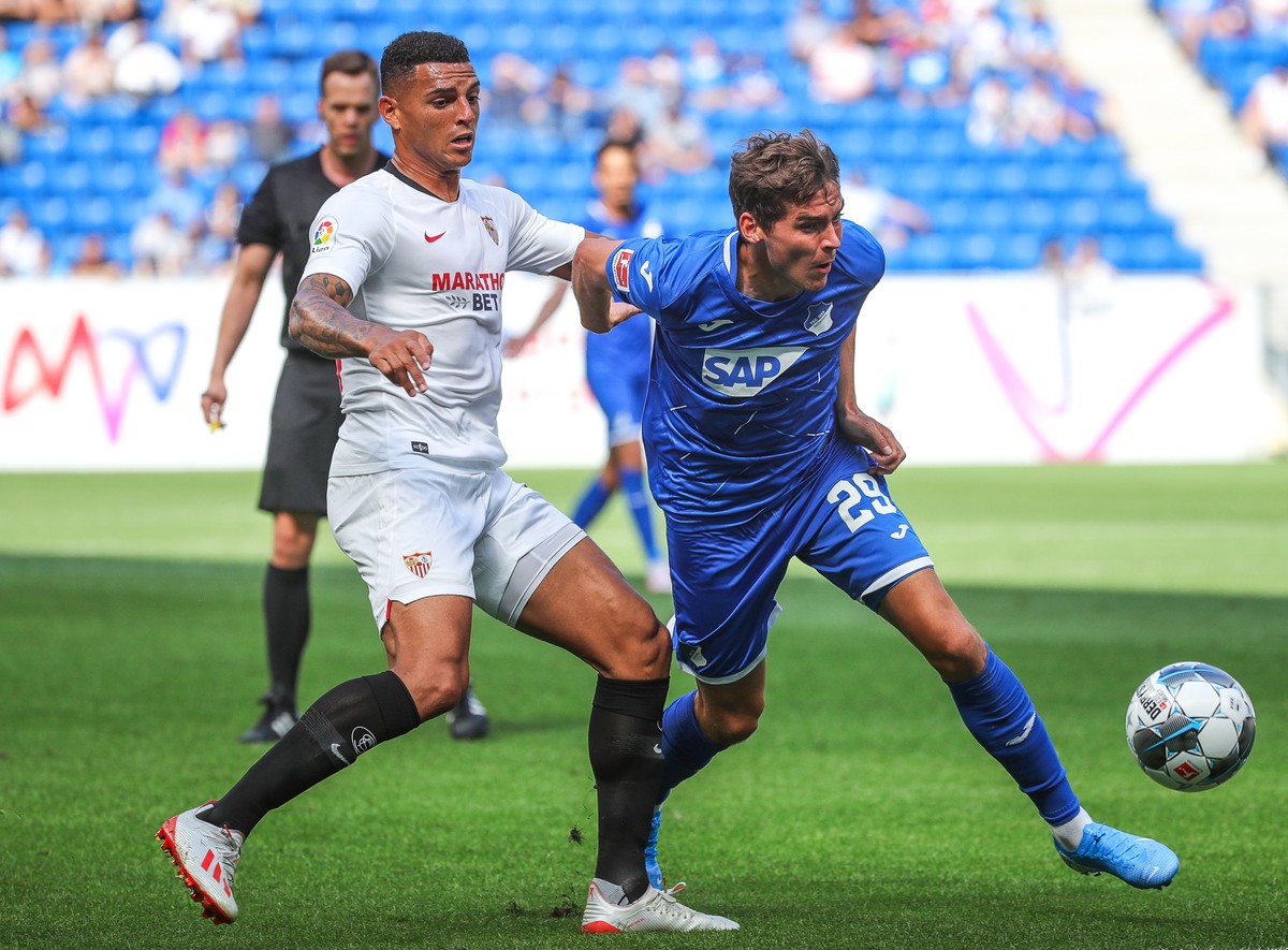 epa07755114 Sevilla's Diego Carlos (L) in action against Hoffenheim's Robert Skov (R) during the friendly soccer match between TSG 1899 Hoffenheim and Sevilla FC in Sinsheim, Germany, 03 Aug ...