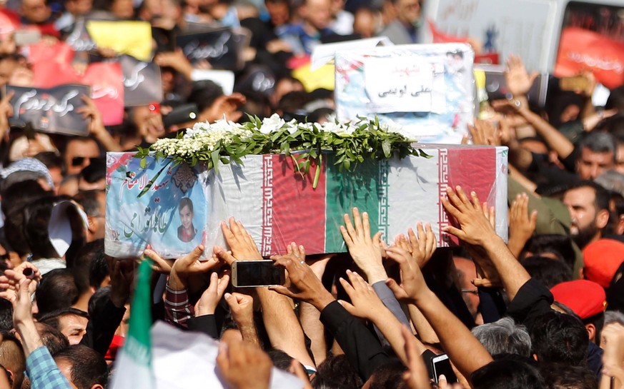 epa07042949 Iranians carry the coffins of the victims of recent terror attack during a funeral ceremony in the city of Ahvaz, southern Iran, 24 September 2018. Media reported that gunmen have opened f ...