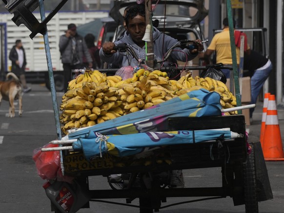 Clowns walk past a banana vendor as they arrive to take part in a march for the first time after two years of COVID-19 pandemic restrictions kept them from celebrating The Day of the Peruvian Clown, i ...