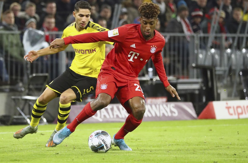Bayern's Kingsley Coman, right, duels for the ball with Dortmund's Achraf Hakimi during the German Bundesliga soccer match between FC Bayern Munich and Borussia Dortmund, in Munich, Germany, ...