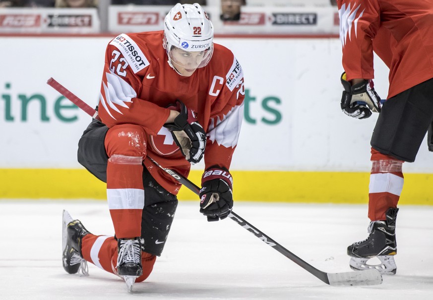 Switzerland&#039;s Nando Eggenberger pauses on the ice after being stopped by Canada goalie Ian Scott during the third period of a world junior hockey championship game Thursday, Dec. 27, 2018, in Van ...