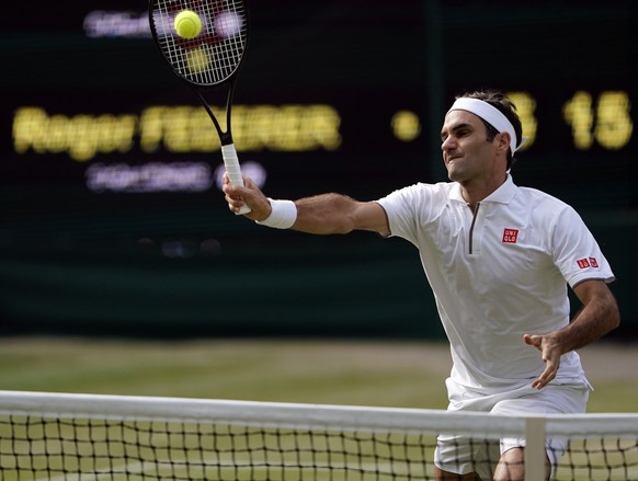 epa07712866 Roger Federer of Switzerland returns to Rafael Nadal of Spain in their semi final match during the Wimbledon Championships at the All England Lawn Tennis Club, in London, Britain, 12 July  ...