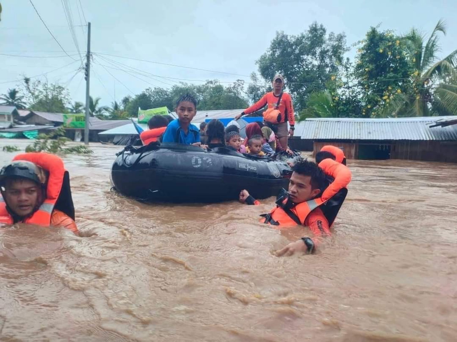 epa10270774 A handout photo made available by Philippine Coast Guard (PCG) shows coast guard personnel conducting a rescue operation in the flood-hit town of Parang, Maguindanao, Philippines, 28 Octob ...