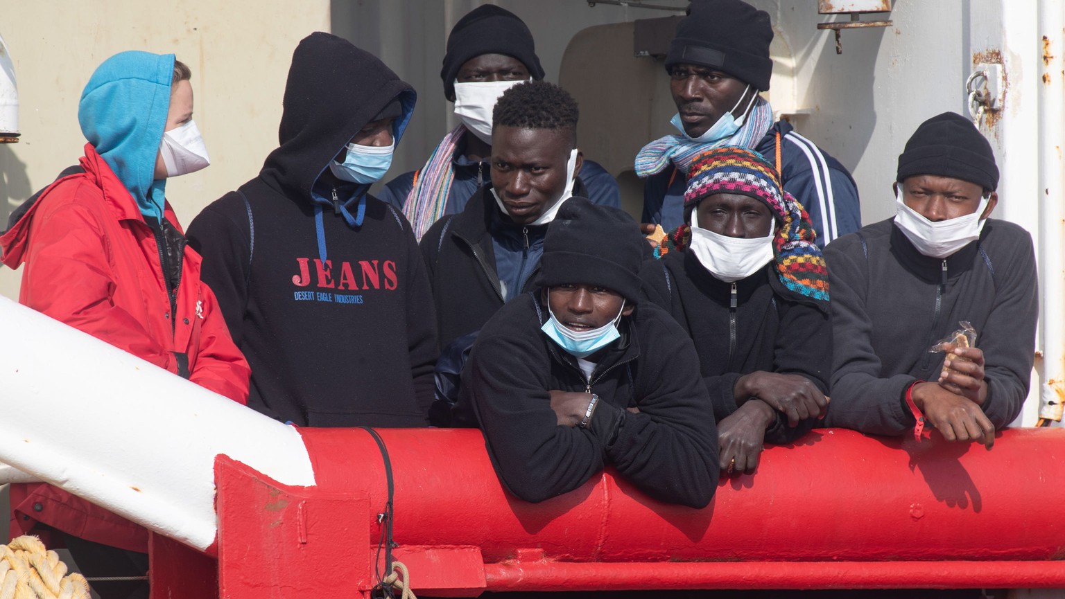 epa10474771 A group of migrants waits to disembark the rescue ship &#039;Ocean Viking&#039; of the NGO &#039;SOS Mediterranee&#039; after it arrived and moored at the port of Ravenna, Italy, 18 Februa ...