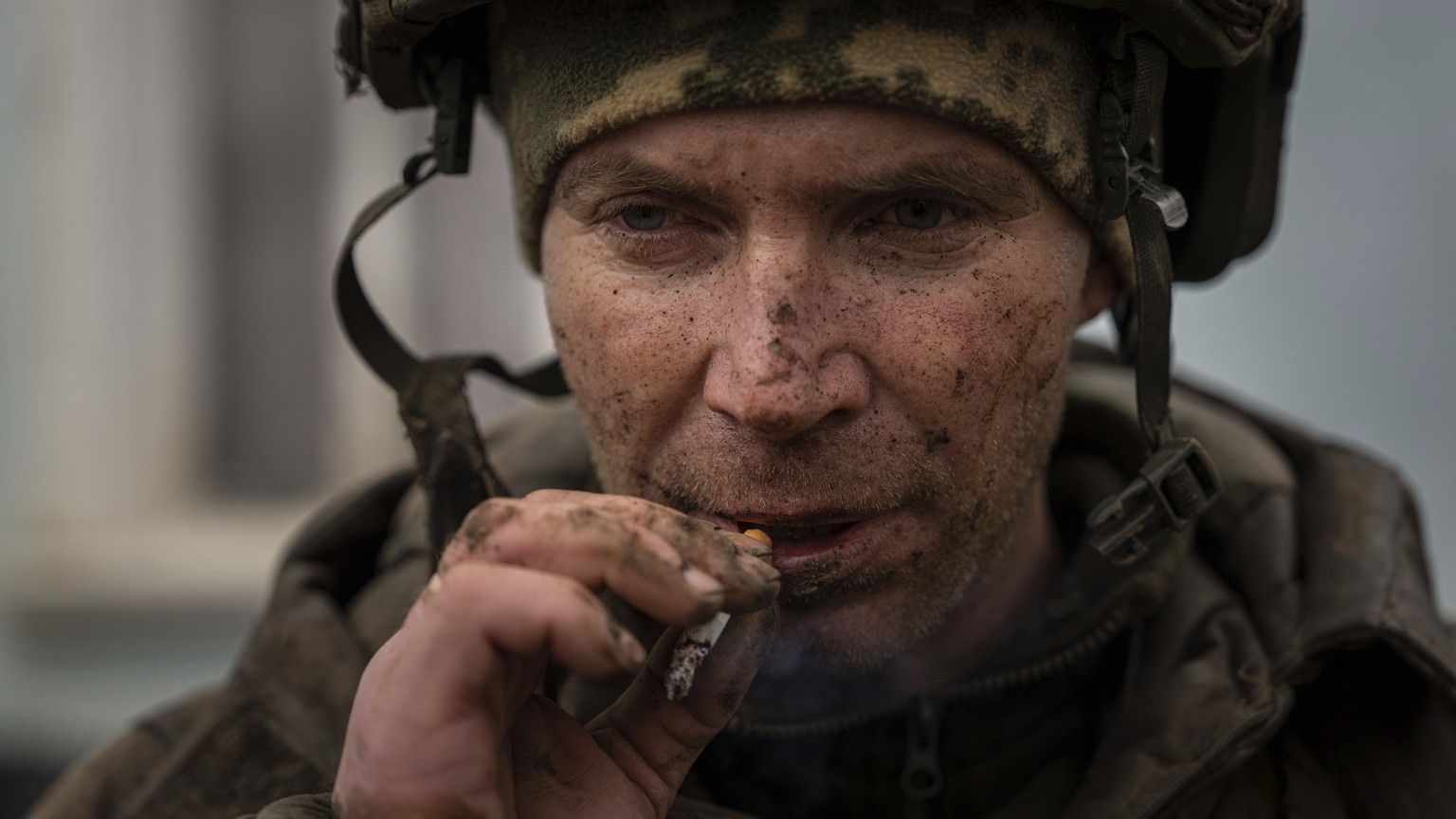 A Ukrainian serviceman who recently returned from the trenches of Bakhmut smokes a cigarette in Chasiv Yar, Ukraine, Wednesday, March 8, 2023. (AP Photo/Evgeniy Maloletka)