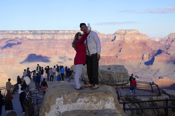 Tourists take pictures at the Mather Point overlook in Grand Canyon National Park, Wednesday, Jan. 31, 2024, in Grand Canyon, Ariz. (AP Photo/Ross D. Franklin)