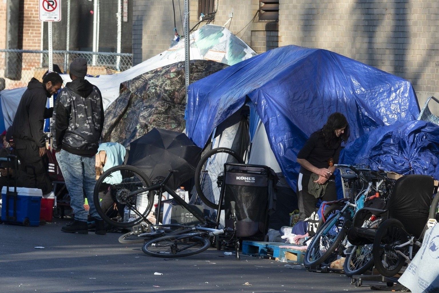 The tents of a homeless camp line the sidewalk in area commonly known as Mass and Cass, Saturday, Oct. 23, 2021, in Boston. Boston declared addiction and homelessness a public health emergency on Tues ...