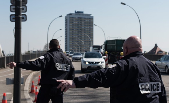 epa05268410 Officials of the French National Police make raodside checks on cars driving from Germany over the Rhine bridge in Strasbourg, France, 20 April 2016. France has extended border cotrols due ...