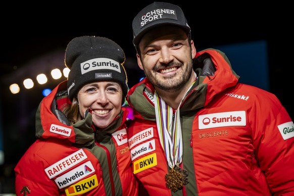 Bronze medalist Loic Meillard of Switzerland poses with his two medals next to Zoe Chastan, Communications Manager Alpine Skiing for Swiss-Ski Federation during the medals ceremony of the men&#039;s G ...