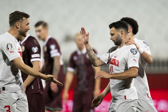 Switzerland&#039;s defender Silvan Widmer, midfielder Renato Steffen and midfielder Ruben Vargas, from left, celebrate after Steffen scored 0-3 during the UEFA Euro 2024 qualifying group I soccer matc ...