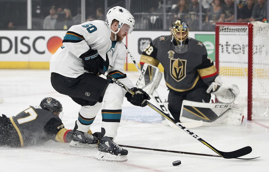 Vegas Golden Knights defenseman Luca Sbisa (47) knocks the puck away from San Jose Sharks center Chris Tierney during the first period of Game 5 of an NHL hockey second-round playoff series, Friday, M ...