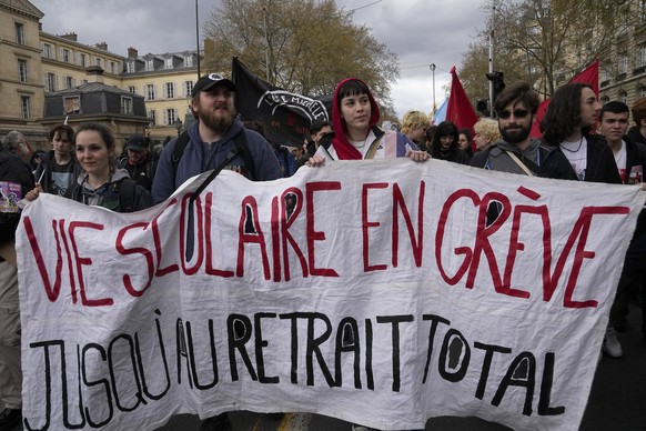 Demonstrators march during a protest Thursday, April 6, 2023 in Paris. Hundreds of thousands of people are expected to fill the streets of France Thursday for the 11th day of nationwide resistance to  ...