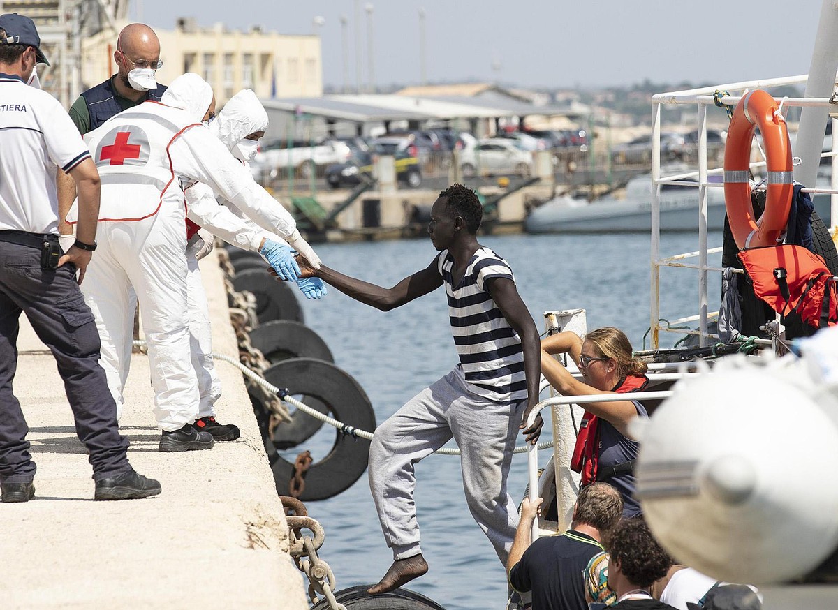 Migrants disembark from the German rescue boat Eleonore in the port of Pozzallo, Sicily, Southern Italy, Monday, Sept. 2, 2019. Italy's interior minister is vowing to make the charity boat with s ...