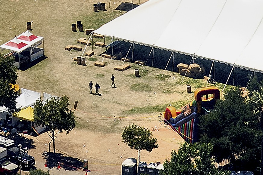 Investigators examine an area by an inflatable slide at Christmas Hill Park, the scene of Sunday&#039;s deadly shooting, Monday, July 29, 2019, in Gilroy, Calif. Authorities on Monday were searching f ...