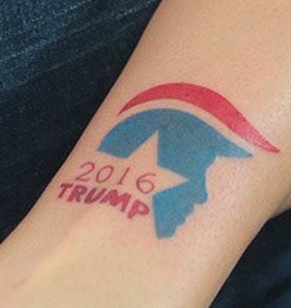 Katie Furr looks at her new Donald Trump tattoo at the Electroluxe Tattoo Company in Panama City Beach, Fla., on Saturday, July 23, 2016. The shop hosted a "Tats for Trumps" event, offering ...