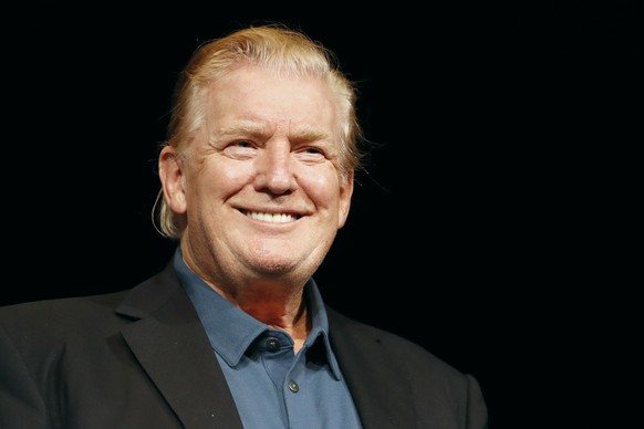 President Donald Trump smiles as he arrives on stage to receive a prayer at McLean Bible Church, in Vienna, Va., Sunday June 2, 2019. (AP Photo/Jacquelyn Martin)